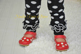 Black and white polka dot leg warmers with a ruffle.