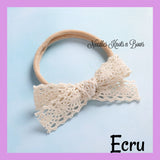 Ecru lace trim bow headband for baby girls and toddlers..  This headband is a great choice for adding to your little one's bow collection or getting it started.