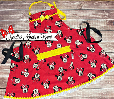 Girls red & yellow Minnie Mouse cooking apron with a pocket.  Kids love to help out in the kitchen, bake for the holidays and they will be super excited to have an apron