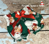 Baby girls - toddlers - girls Santa Bloomers.  Santa Clause on a Christmas green background with a satin ribbon bow on the front making these a “Must Have” for your little one during the Holiday Season..