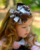 Layered boutique football hair bow with feathers.