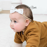 Baby girls white crochet lace trim bow nylon headband.  Nylon headbands are very soft and comfortable for babies and toddlers and  never leave a compression mark.