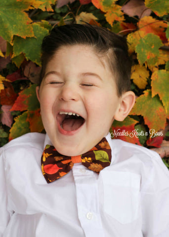 Fall leaves on brown bow tie.