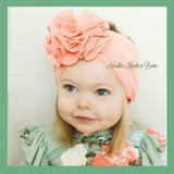 Peach messy bow headband for baby girls and toddlers.