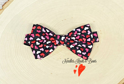 Red and pink hearts on black Valentine's Day bow tie