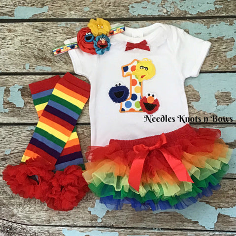 Sesame Street First Birthday Outfit Girl.  Rainbow ruffled bloomers paired with a darling first birthday onesie and you choose to add on the matching heafband and or rainbow striped leg warmers. 